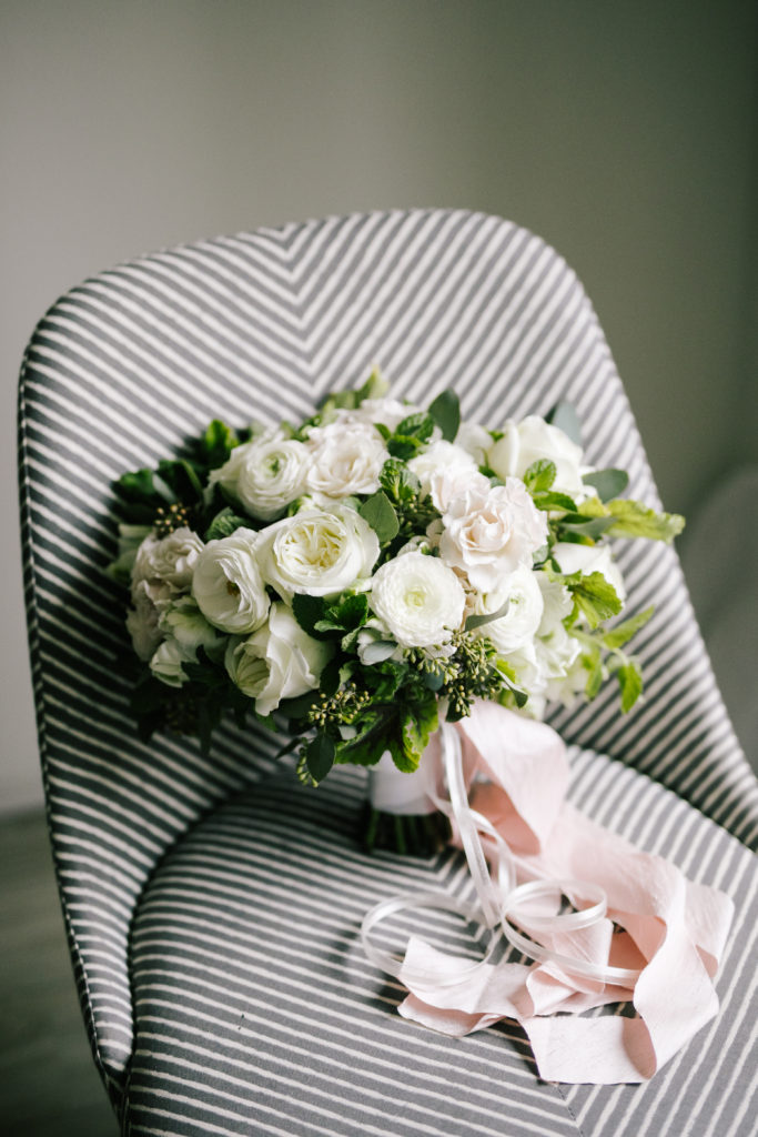 White bridal bouquet designed by Alicia Schwede and Photographed by Kelly Lemon. Bouquet of white roses and ranunculus