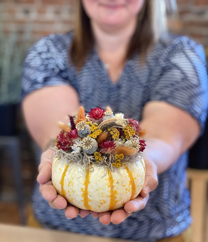 White pumpkin decorated with dried flowers and foliages at our floral design class in Snohomish