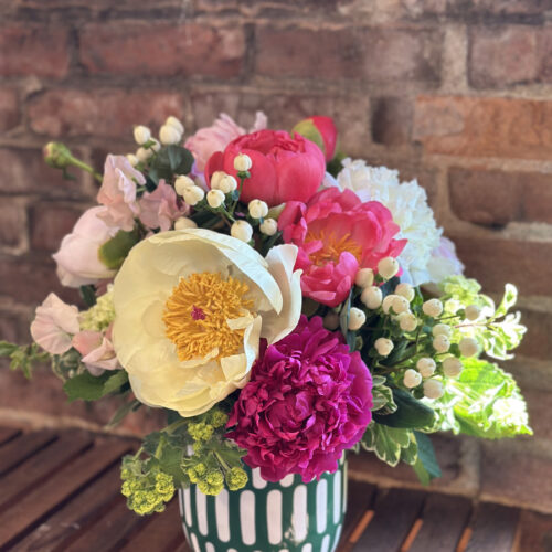 multi-colored peonies arranged in a green vase from a workshop at Fleurs Creative in Snohomish Washington